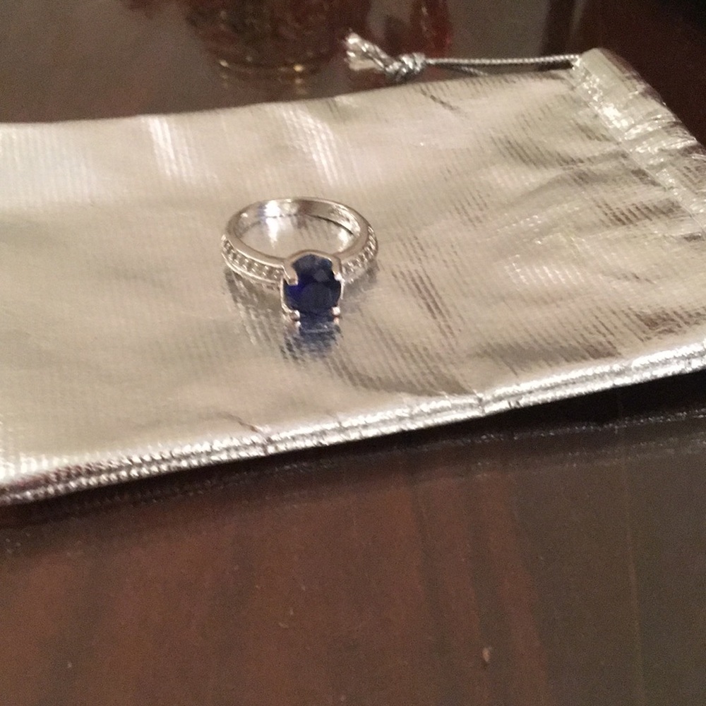 Ring with dark blue stone and diamond accents